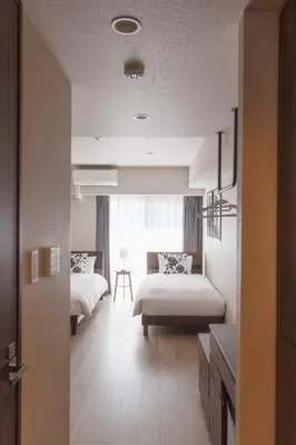 a bedroom with two beds and a window at LANG HOTEL Kameido - Vacation STAY 79460v in Tokyo