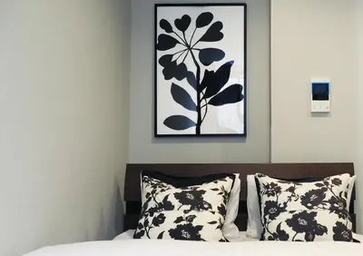 a bedroom with a picture above a bed with pillows at LANG HOTEL Kameido - Vacation STAY 71097v in Tokyo