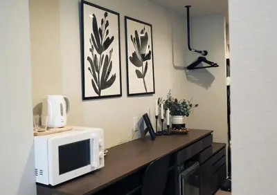 a microwave sitting on top of a wooden counter in a room at LANG HOTEL Kameido - Vacation STAY 71097v in Tokyo