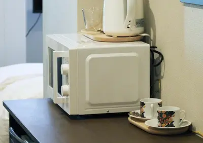 a coffee maker and two cups on a microwave at LANG HOTEL Kameido - Vacation STAY 71097v in Tokyo