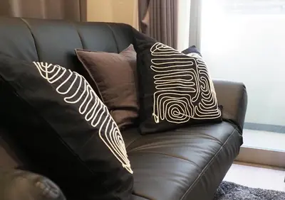 a black leather couch with two pillows on it at LANG HOTEL Kameido - Vacation STAY 71097v in Tokyo