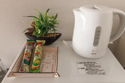 a white vase sitting on a table next to a box at LANG HOTEL Kameido - Vacation STAY 76961v in Tokyo