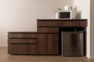 a microwave sitting on top of a wooden entertainment center at LANG HOTEL Kameido - Vacation STAY 76961v in Tokyo