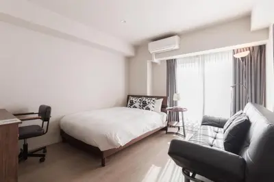 a bedroom with a bed and a couch at LANG HOTEL Kameido - Vacation STAY 79080v in Tokyo
