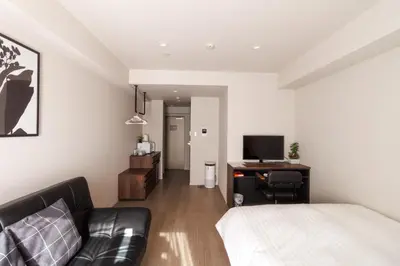 a bedroom with a bed and a desk with a television at LANG HOTEL Kameido - Vacation STAY 76836v in Tokyo