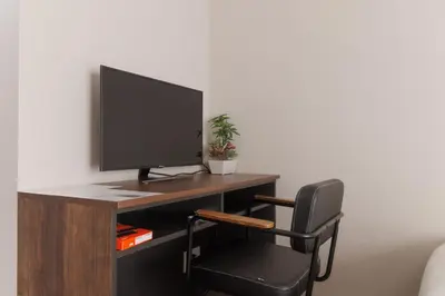 a computer desk with a monitor and a chair at LANG HOTEL Kameido - Vacation STAY 76836v in Tokyo