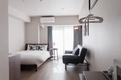 a bedroom with a bed and a chair and a window at LANG HOTEL Kameido - Vacation STAY 76905v in Tokyo