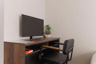 a computer desk with a monitor and a chair at LANG HOTEL Kameido - Vacation STAY 76905v in Tokyo