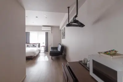 a bedroom with a bed and a living room at LANG HOTEL Kameido - Vacation STAY 76954v in Tokyo