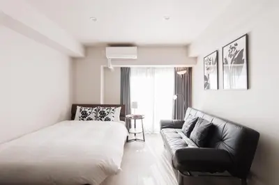 a bedroom with a bed and a couch at LANG HOTEL Kameido - Vacation STAY 79234v in Tokyo