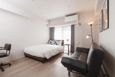 a bedroom with a bed and a couch and a chair at LANG HOTEL Kameido - Vacation STAY 79133v in Tokyo