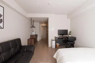 a room with a bed and a couch and a television at LANG HOTEL Kameido - Vacation STAY 79133v in Tokyo