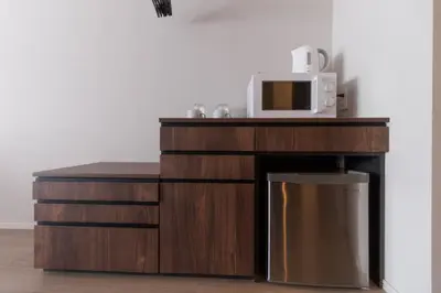 a microwave oven sitting on top of a wooden cabinet at LANG HOTEL Kameido - Vacation STAY 76922v in Tokyo
