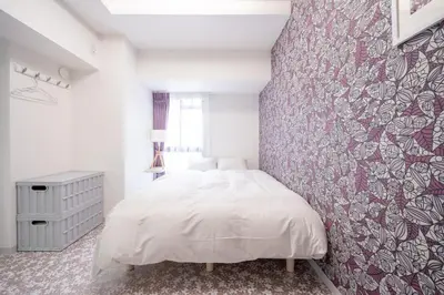 a bedroom with a white bed and a red wall at Ilman Hishimo Mansion - Vacation STAY 19418 in Tokyo