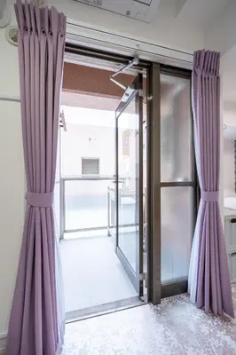 an open door with purple curtains in a room at Ilman Hishimo Mansion - Vacation STAY 19418 in Tokyo