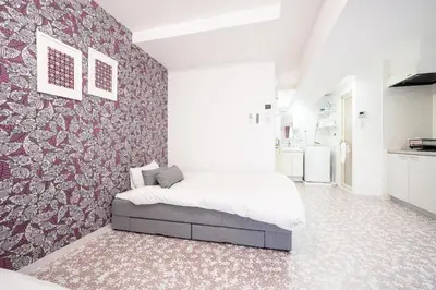 a bedroom with a large bed in a room at Ilman Hishimo Mansion - Vacation STAY 19418 in Tokyo