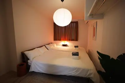 a bedroom with a large white bed with a lamp at Nakano-ku - House - Vacation STAY 19255 in Tokyo