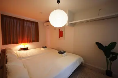 a bedroom with a large white bed with a lamp at Nakano-ku - House - Vacation STAY 19255 in Tokyo
