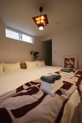 a bedroom with two beds with towels on them at Nakano-ku - House - Vacation STAY 19255 in Tokyo