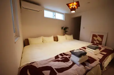 a bedroom with a large bed with towels on it at Nakano-ku - House - Vacation STAY 19255 in Tokyo