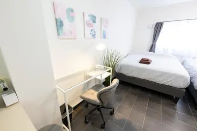 a bedroom with a bed and a desk and a chair at Kodenmacho Building Room 201 - Vacation STAY 38318v in Tokyo