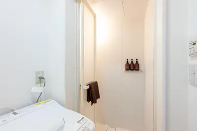 a bathroom with a shower with bottles on the door at Kodenmacho Building Room 201 - Vacation STAY 38318v in Tokyo