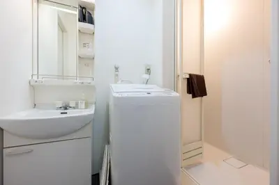 a white bathroom with a sink and a mirror at Kodenmacho Building Room 201 - Vacation STAY 38318v in Tokyo