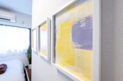 a row of paintings on a wall in a room at Kodenmacho Building Room 201 - Vacation STAY 38292v in Tokyo