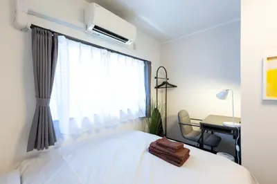 a bedroom with a bed and a desk and a window at Kodenmacho Building Room 201 - Vacation STAY 38292v in Tokyo
