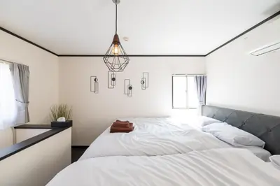 a bedroom with a large white bed and a chandelier at Kodenmacho Building Room 201 - Vacation STAY 38324v in Tokyo