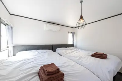 a bedroom with two white beds with towels on them at Kodenmacho Building Room 201 - Vacation STAY 38324v in Tokyo