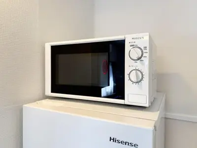 a microwave oven sitting on top of a white box at Kodenmacho Building Room 201 - Vacation STAY 38324v in Tokyo