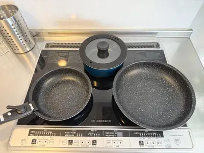 two frying pans sitting on top of a stove at Kodenmacho Building Room 201 - Vacation STAY 38324v in Tokyo