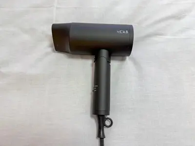 a black hair dryer sitting on top of a bed at Kodenmacho Building Room 201 - Vacation STAY 38324v in Tokyo