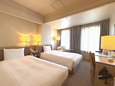 a hotel room with two beds and a desk at Smile Hotel Tokyo Nishikasai - Vacation STAY 67970v in Tokyo