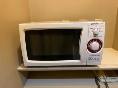 a white microwave oven sitting on top of a shelf at Smile Hotel Tokyo Nishikasai - Vacation STAY 67970v in Tokyo