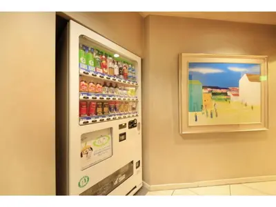 a vending machine with soda and a picture on the wall at Smile Hotel Tokyo Nishikasai - Vacation STAY 67938v in Tokyo