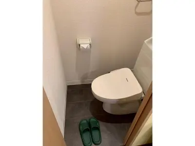 a bathroom with a toilet and two green slippers at HOTEL PRELE Asakusa - Vacation STAY 74351v in Tokyo