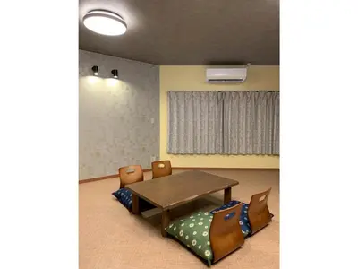 a dining room with a wooden table and chairs at HOTEL PRELE Asakusa - Vacation STAY 74351v in Tokyo
