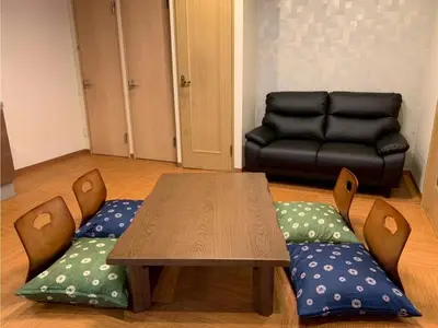 a living room with a table and a couch at HOTEL PRELE Asakusa - Vacation STAY 74363v in Tokyo