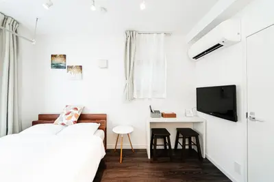 a bedroom with a bed and a desk and a tv at NDZ203 3 min walk to station, 2 lines, Yamanote Line, high-speed Wi-Fi in Tokyo