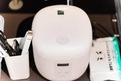 a white router sitting on top of a desk at NDZ401 3 min walk to station, 2 lines, Yamanote line to Tokyo, high-speed Wi-Fi in Tokyo