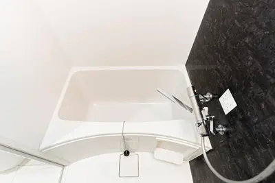 a white shower in a bathroom with a hose at NDZ401 3 min walk to station, 2 lines, Yamanote line to Tokyo, high-speed Wi-Fi in Tokyo