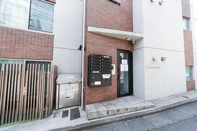 a door to a brick building with a sign on it at NDZ403 3 min walk to station, 2 lines, Yamanote line to explore Tokyo, high-speed Wi-Fi in Tokyo