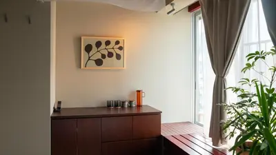 a living room with a dresser and a window at SOIL Nihonbashi Hotel in Tokyo