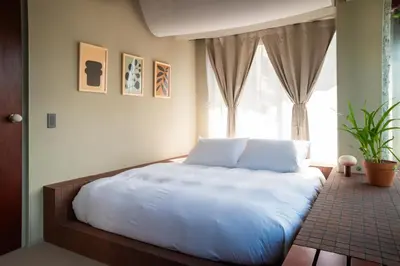 a bedroom with a large white bed with a window at SOIL Nihonbashi Hotel in Tokyo