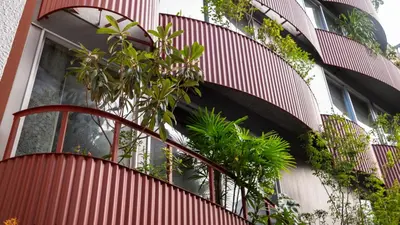 a building with a spiral staircase with plants on it at SOIL Nihonbashi Hotel in Tokyo