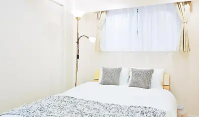 a bedroom with a white bed and a window at \u9326\u7cf8\u753a\u30fc804 in Tokyo