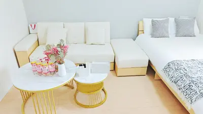 a small room with two beds and a table at \u9326\u7cf8\u753a\u30fc804 in Tokyo