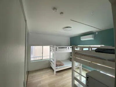 a room with two bunk beds and a window at Tokyo Skytree Tower - Asakusa Auberge de Jeunesse in Tokyo